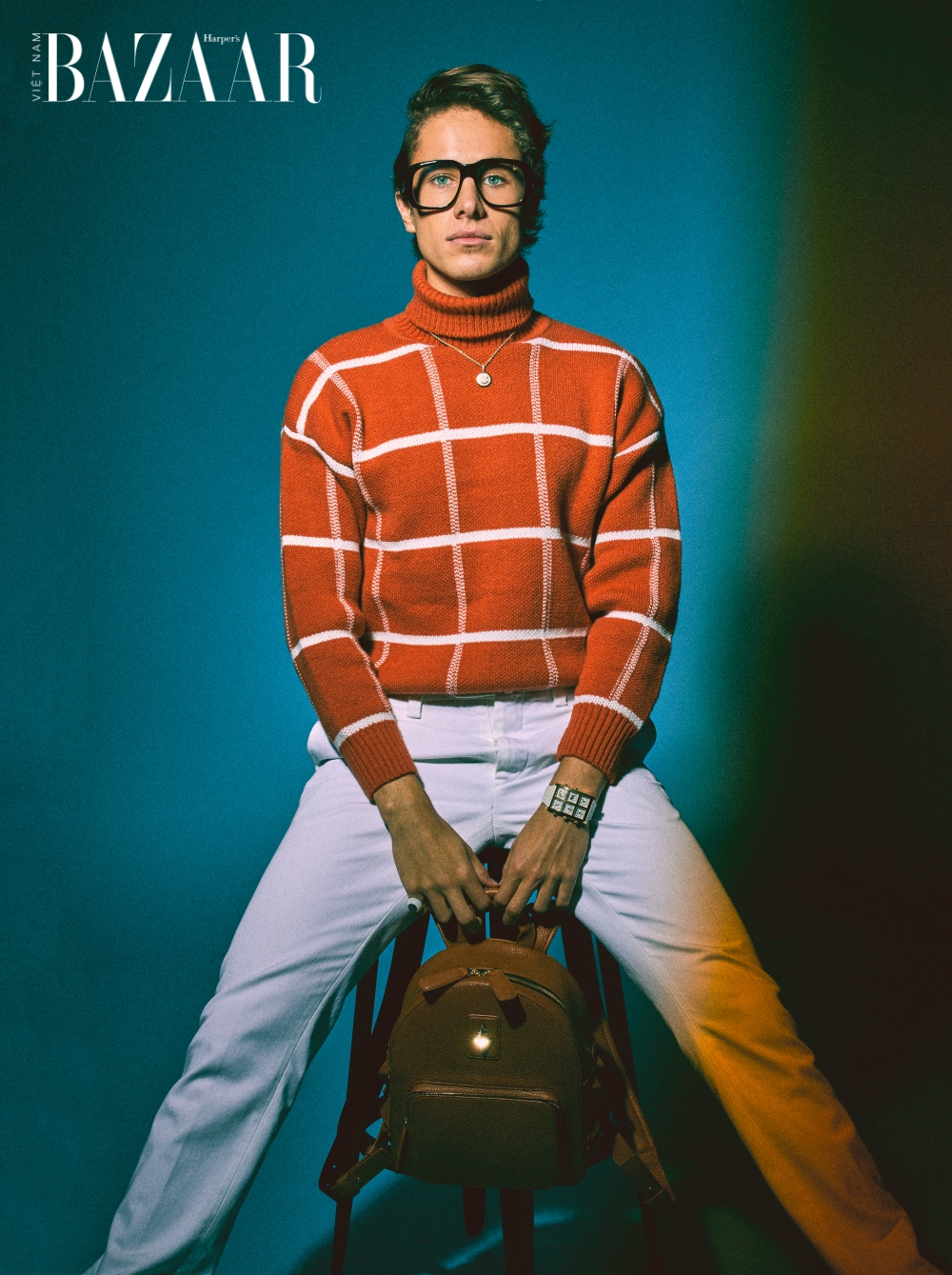 Trang phục: Áo chemise, Alain Taylor (áo len kẻ sọc màu cam) @ALANITAYLORCO. Quần, Stile Latino (Trắng) @STILE_LATINO. Trang sức: Barnett (Vòng cổ mặt cười); Nhẫn, ONCH RING; Đồng hồ, ICE LINK @ BY.BARNETT @ONCH @ICELINKOFFICIAL. Phụ kiện: ba-lô SOFIA AL ASFOOR PRIVE PORTER @PRIVEPORTER.